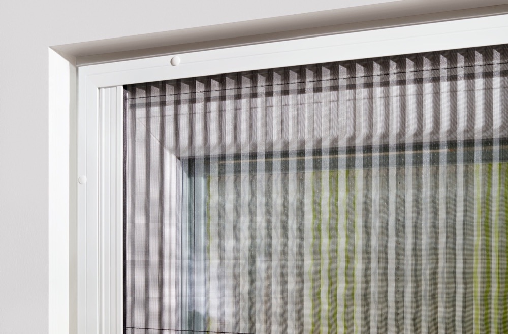 Close-up of pleated mesh at a window frame